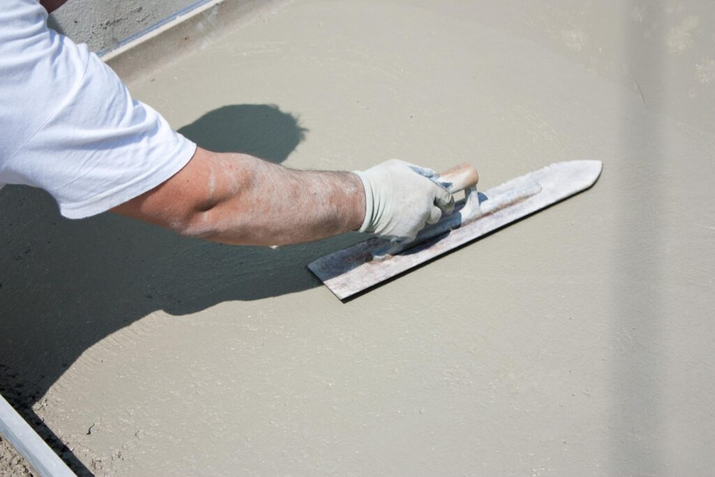 man flattening the concrete cement