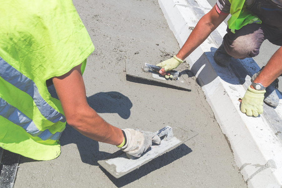 men flattening the concrete cement