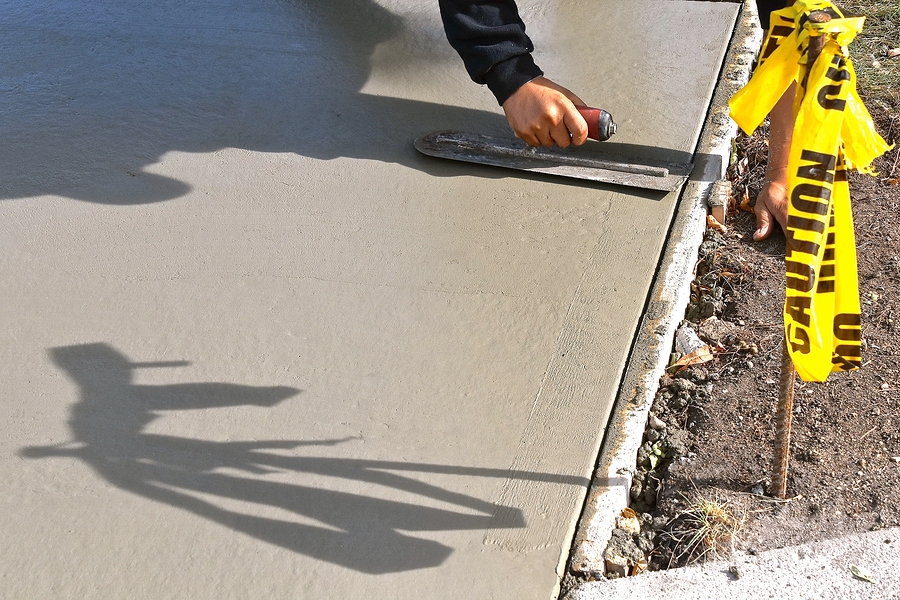 man flattening the concrete cement